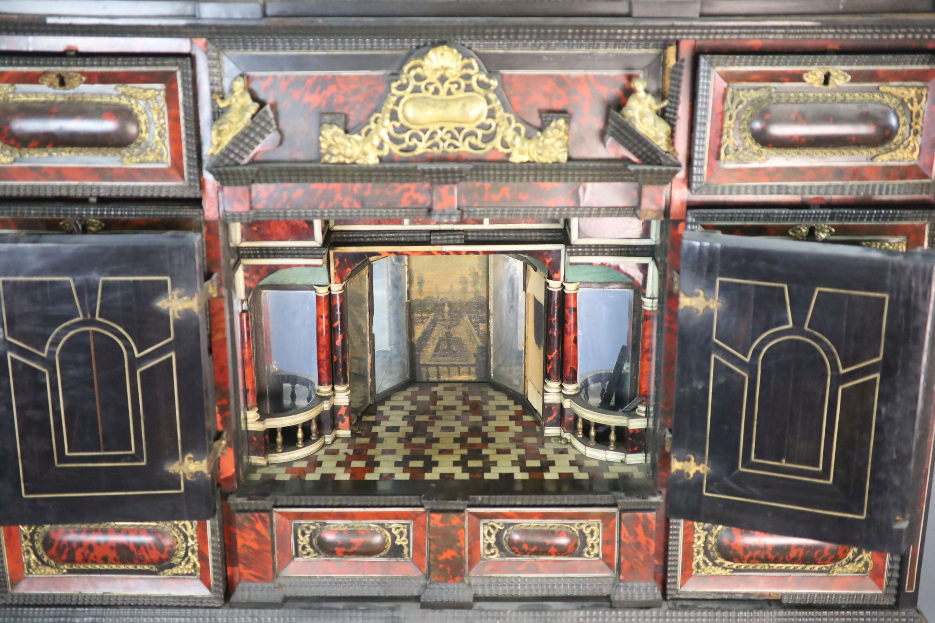 A late 17th century Portuguese ormolu mounted ebony and red tortoiseshell cabinet on stand, W.124cm D.46cm H.187cm